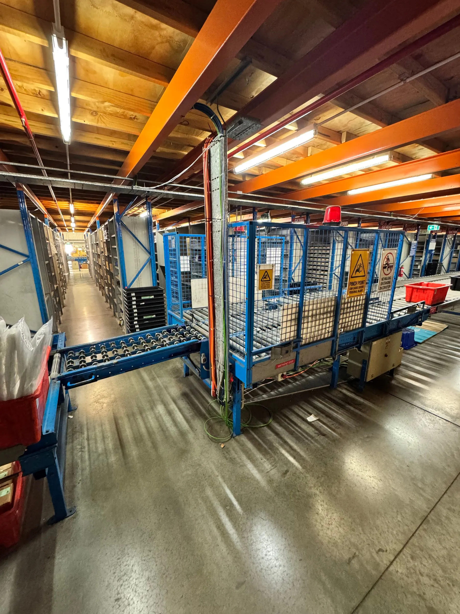 Wide view of electricians from CPR Electrical upgrading an automated conveyor system at a WA industrial facility