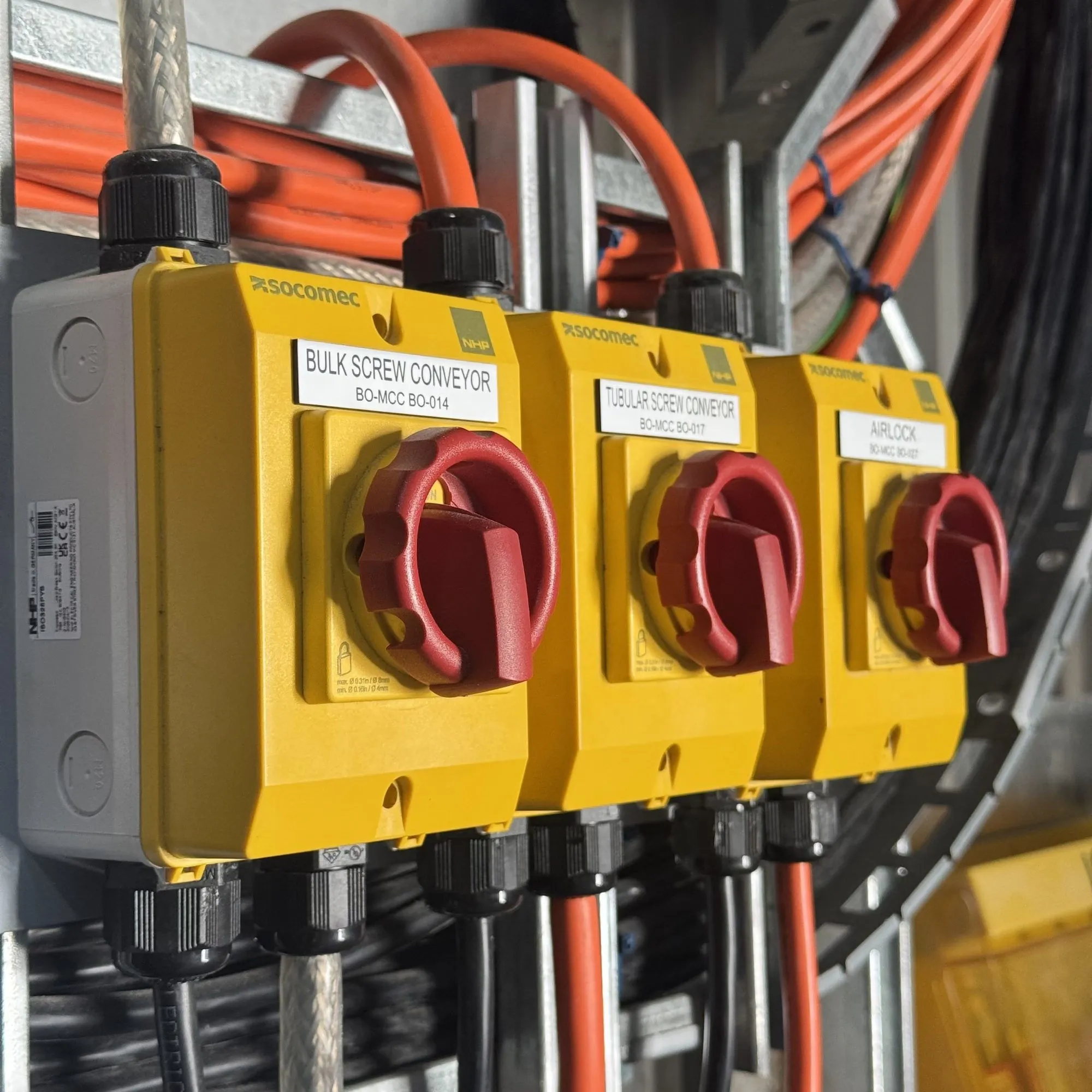 Three yellow rotary isolators labelled for bulk and tubular screw conveyors and an airlock