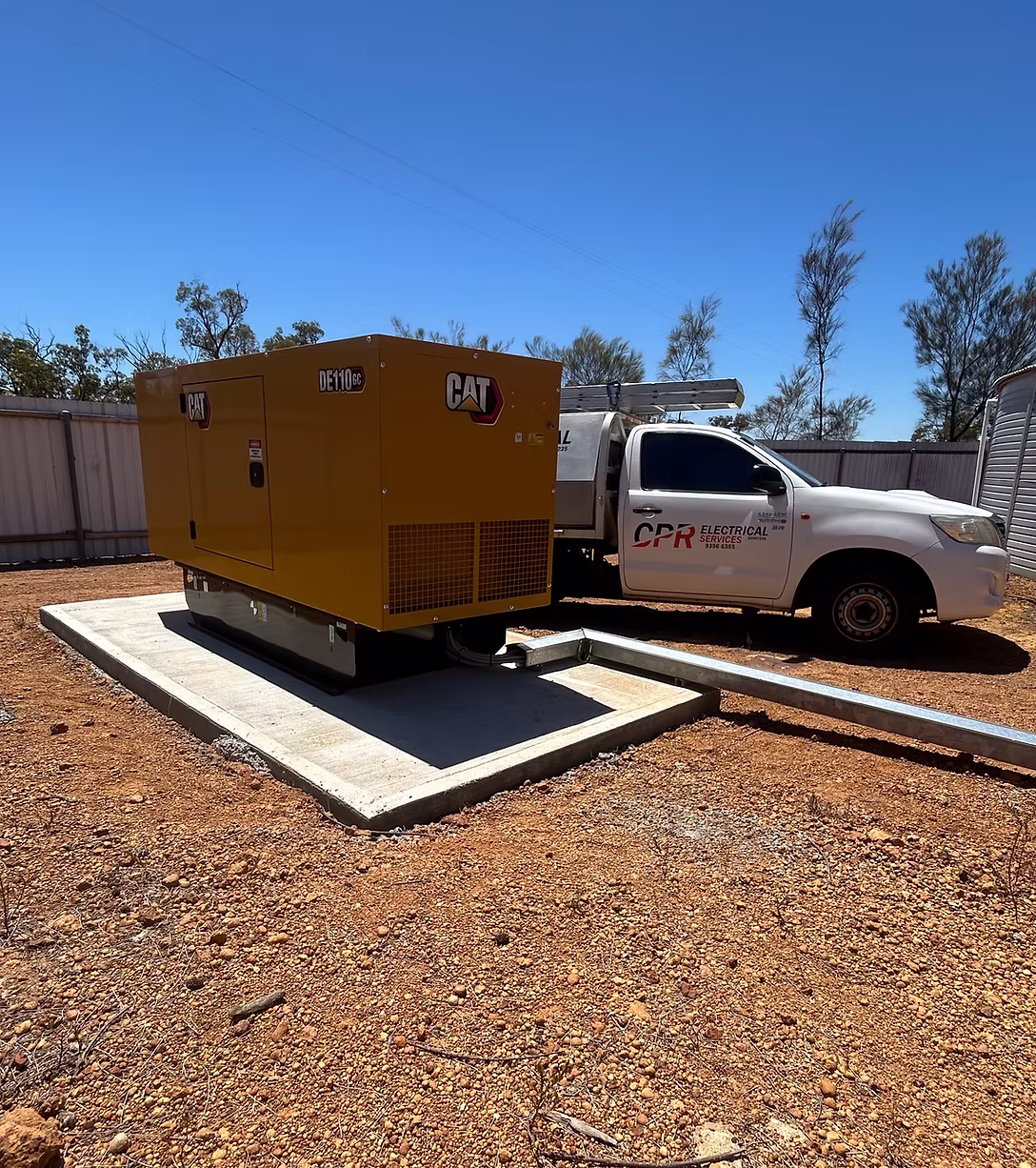 Cat DE110 GC generator on its concrete pad with a CPR Electrical service ute parked alongside